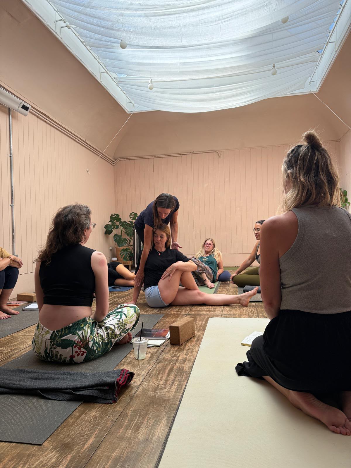 Yoga teaching and hands-on guidance in a studio setting